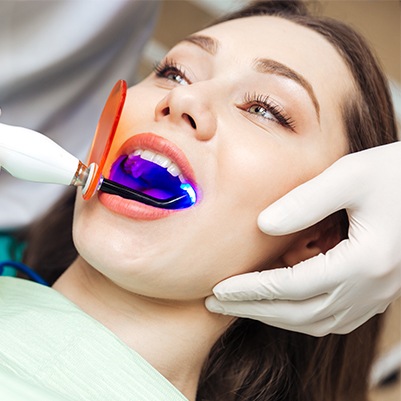 Female patient receiving dental bonding treatment