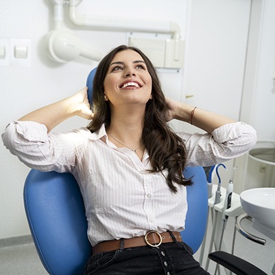 smiling woman giving a thumbs up at her sedation dentist in Frisco 
