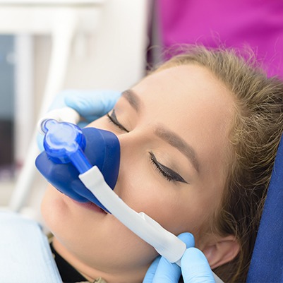 Female patient with nitrous oxide dental sedation mask in place
